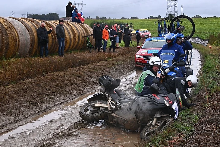 A motorbike carrying a photographer slips on the cobblestone during the 118th edition of the ParisRoubaix oneday classic cycling race between Compiegne and Roubaix northern France on October 3 2021 Photo by AnneChristine POUJOULAT AFP Photo by ANNECHRISTINE POUJOULATAFP via Getty Images